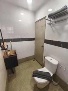 a bathroom with a toilet with a towel on it at Ayu Blue Lagoon PD by GPH in Port Dickson