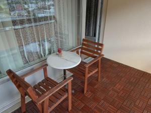 a table and two chairs sitting next to a window at Holiday apartment Constantin in Davos