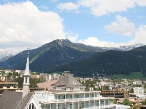 a view of a city with a church and a mountain at Holiday apartment Constantin in Davos