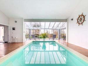 a swimming pool in a house with a large window at DUXCAAR Mervent in Mervent