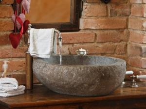a bathroom sink with a stone bowl with water at Holiday apartment with 1 bedroom in Furth im Wald +23 photos