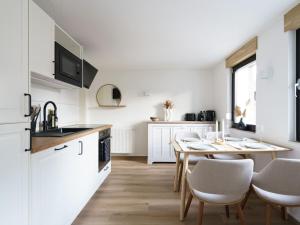 Holiday home Ahorn, 1st floor في Weilerswist: مطبخ وغرفة طعام مع طاولة وكراسي
