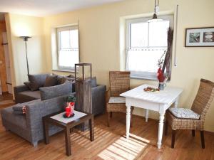 a living room with a couch and a table at Holiday apartment with 1 bedroom in Furth im Wald