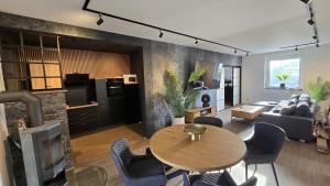 a living room with a table and a couch at Ferienhaus-Kleine-Austernperle in Dornumersiel