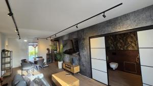 a living room with a couch and a table at Ferienhaus-Kleine-Austernperle in Dornumersiel +17 photos