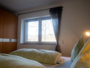 a bedroom with a bed and a window at Apartment with 1 bedroom in Einruhr