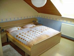 a bedroom with a bed with a wooden headboard at Holiday apartment in Rhön with 1 bedroom in Ehrenberg
