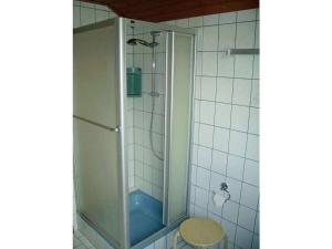 a shower with a glass door in a bathroom at Holiday apartment in Rhön with 1 bedroom in Ehrenberg +12 photos