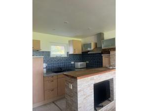 a kitchen with wooden cabinets and a stone counter top at Holiday home on Lake Kummerow in Salem +6 photos