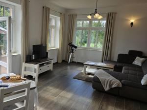 a living room with a couch and a tv at Manor house apartment in Barlin