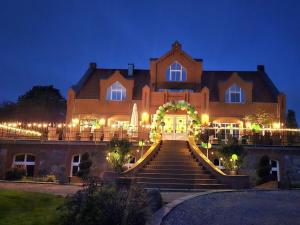 a large house with stairs leading up to it at night at Manor house apartment in Barlin