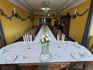 a long table with white flowers and candles on it at Manor house apartment in Barlin
