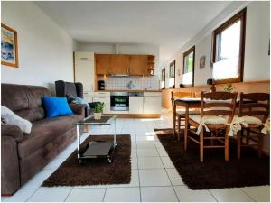 a living room with a couch and a table at 2 Weinhaus Marmann in Osann-Monzel