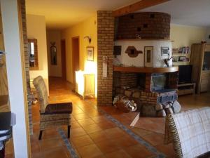 a living room with a brick fireplace in a house at Holiday apartment with 3 bedrooms in Holzendorf