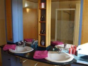 a bathroom with two sinks and a large mirror at Holiday apartment with 3 bedrooms in Holzendorf +20 photos