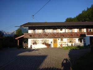 a large building with a balcony on the side of it at Untersberg in Punzenlehen in Engedey