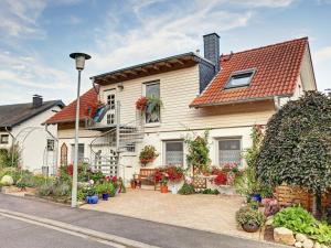 a white house with a red roof at Close-up view inside the Vorbek house in Bärenbach
