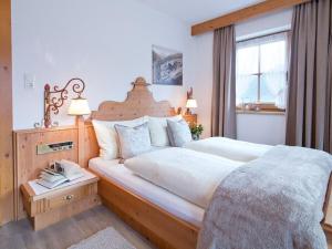 a bedroom with a large bed and a window at Holiday apartment Tristnerblick in the Huaterhof in Laimach