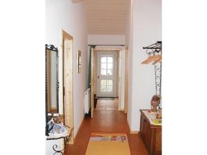 a hallway with white walls and a door with a window at Close-up view inside the Vorbek house in Bärenbach