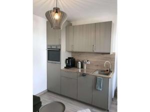 a kitchen with gray cabinets and a sink at Holiday apartment with 1 bedroom in Oberbach