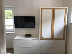 a white cabinet with a television on top of it at Holiday apartment with 1 bedroom in Oberbach +7 photos