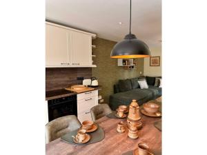 a kitchen and living room with a table and a couch at Holiday home Burgblick in Kranichfeld +8 photos