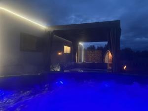 a dark room with a pool at night at Trailer in 03058 with swimming pool in Haasow