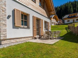 a patio with chairs and a table on a house at Haus Elau in Donnersbachwald