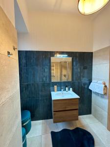 a bathroom with a sink and a mirror at Centro Storico Suites Sarnico in Sarnico