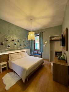 a bedroom with a large bed and a chandelier at Centro Storico Suites Sarnico in Sarnico