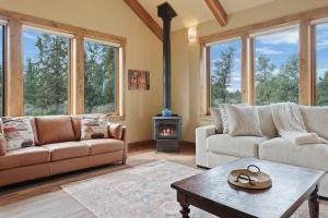 a living room with two couches and a wood stove at High Lowe in Bend
