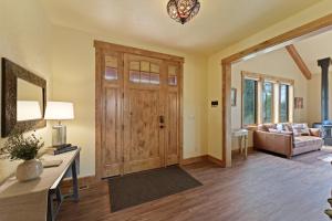 a living room with a wooden door and a couch at High Lowe in Bend