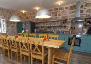 RušićiにあるLuxury villa with a swimming pool Mocici, Dubrovnik - 14900の木製のテーブルと椅子のあるキッチン