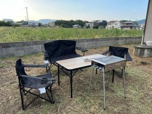 a table and two chairs and a table and a grill at 瀬戸内庵Setouchian in Takamatsu +26 photos