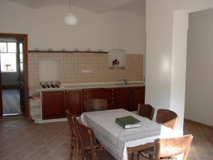 a kitchen with a table and chairs and a kitchen with a stove at Rodinné ubytování na Habeši in Crhov