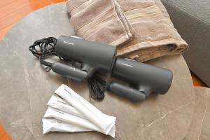 a blow dryer sitting on a table with napkins at LIJ Stay Morinomiya 5BedRooms in Osaka