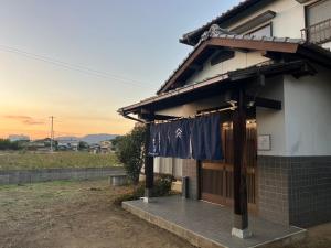 a house with a flag hanging outside of it at 瀬戸内庵Setouchian in Takamatsu