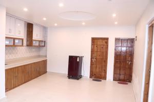 a kitchen with wooden cabinets and a refrigerator at Blest Inn Kasol in Kasol +26 photos