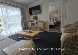 a living room with a couch and a table at Stay n Play n Russell in Russell