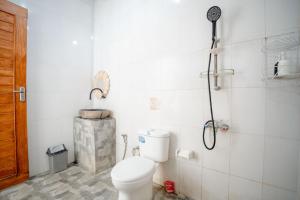 a bathroom with a toilet and a shower at Break Villa Kintamani in Kintamani +20 photos