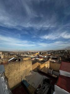 a view of a city with buildings and a sky at Riad Dar Iman in Fès