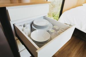 Un cajón blanco con platos y vajilla dentro. en Ninekm Forest Wilderness X by Tiny Away, en Wufeng 13 fotos más