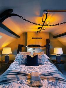 a bedroom with a large bed with two lamps at Rose Cottage in Whitby +93 photos