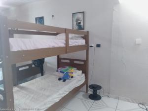 a bedroom with two bunk beds with a stuffed elephant at Pousada Recanto do Mar in Tutóia +98 photos