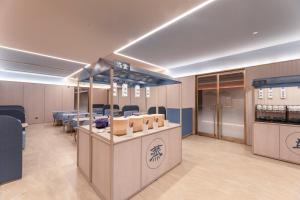 a conference room with tables and chairs and a counter at Hanting Hotel Nanjing Hexi Wanda in Nanjing