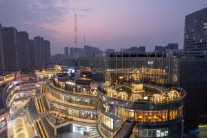 a view of a city at night with buildings at Hanting Hotel Nanjing Hexi Wanda in Nanjing