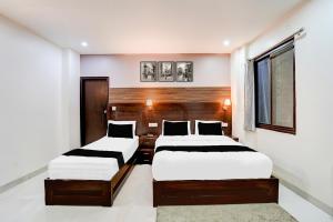 Ένα ή περισσότερα κρεβάτια σε δωμάτιο στο Collection O Prem Nagar Dehradun