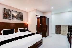 Ένα ή περισσότερα κρεβάτια σε δωμάτιο στο Collection O Prem Nagar Dehradun