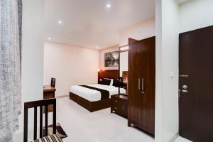 Ένα ή περισσότερα κρεβάτια σε δωμάτιο στο Collection O Prem Nagar Dehradun