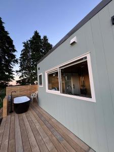 a house with a deck with a window and a tub at Little Hurst House - Escape the Ordinary in Inglewood